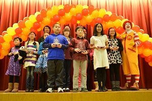 New York City student Aisha Choudhary (right, front row) won the third prize in an essay writing competition by McDonaldâ€™s.
