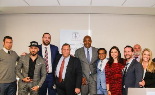 New Jersey Gov. Chris Christie (fourth from left) pose for a photo with other speakers at the American Pain Association's inaugural "Turn the Tide Summit" on December 13, 2017.