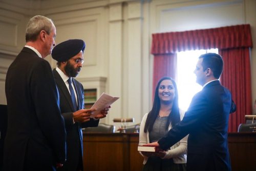 Attorney General Gurbir Grewal administering the oath to lawyer Parthiv Patel, as Governor Phil Murphy (left) looks on.