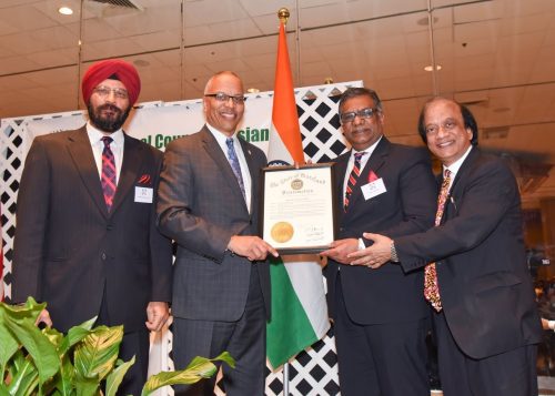 Maryland Lt. Governor Boyd Rutherford (second left) handing over a proclamation from the Governor of Maryland to NCAIA President Pavan Bezwada (second right) and Chairman Dr. Suresh K. Gupta (right).