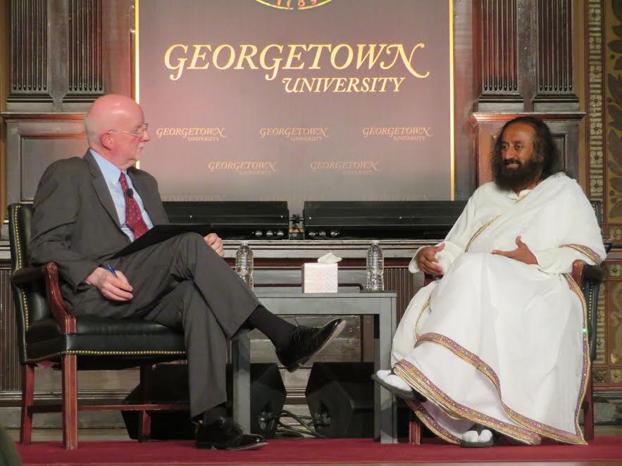 Spiritual leader Sri Sri Ravi Shankar (right) in conversation with Shaun Casey, director of Georgetown University's Berkley Center for Religion, Peace and World Affairs. The event, titled "Interfaith Harmony and Service," was hosted by the university's India Initiative on April 22, 2018, at Georgetown's Gaston Hall.
