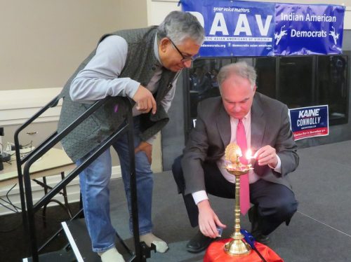 Sen. Tim Kaine lighting the â€œdiyaâ€ (lamp) at a Diwali celebration co-hosted by Democratic Asian Americans of Virginia (DAAV) and Virginia's 11th Congressional District Democratic Committee (CDDC). Looking on at left is Shekar Narasimhan, chairman of AAPI Victory Fund.
