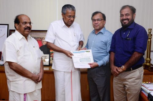 Kerala Chief Minister Pinarayi Vijayan (second from left) receiving a check for $75,000 from KAGW Saju Thomas (second from right) toward the stateâ€™s flood relief fund. On the left is Minister for Public Works Department and Registration G. Sudhakaran.