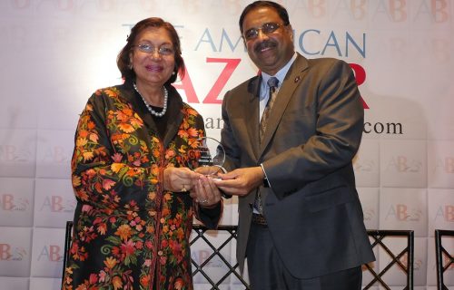 Indian American fundraiser and art collector Mahinder Tak receiving the American Bazaar Woman Leader of the Year award from prominent Indian American entrepreneur Danny Gaekwad in Bethesda, MD, on November 16, 2018.
