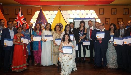 Indu Ganjwani (seated), with members after being sworn in as president of the Long Island Indo American Lions Club