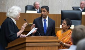 Sri Srinivasan taking the oath of office to serve as judge on the US Court of Appeals for the DC Circuit on the sacred Bhagavad Gita held by his mother Mrs. Saroja Srinivasan (right). Retired Supreme Court Justice Sandra Day O'Connor (left) administered the oath on September 26, 2013. Photo credit: Embassy of India, Washington