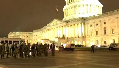 Law-enforcement officials in riot gear guarding the Capitol Hill building on Wednesday evening after it was overran by Trump supporters. Image via C-SPAN